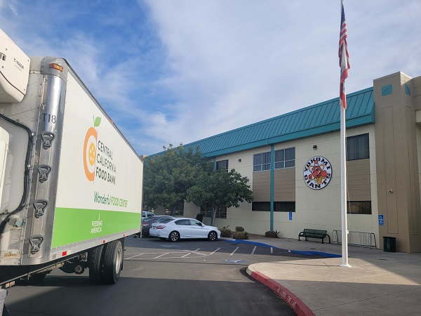 Photo showing a Central California Food Bank truck delivering food to a community organization facility